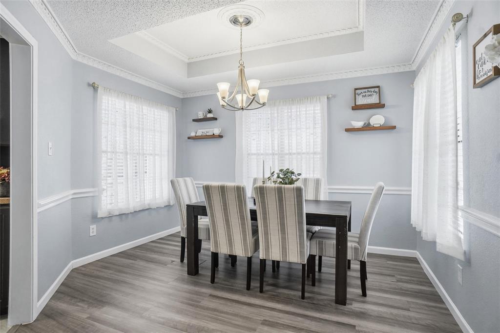 2613 Stone Hollow Drive Bedford, TX 76021 - Photo 11 of 33 a view of a dining room with furniture window and wooden floor