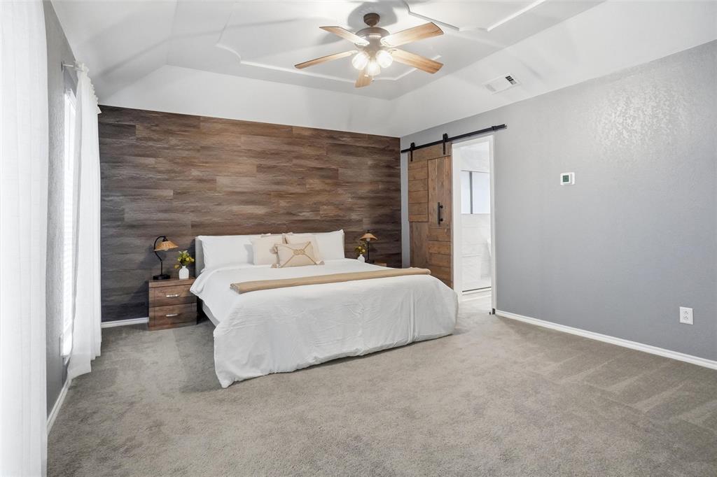 2613 Stone Hollow Drive Bedford, TX 76021 - Photo 13 of 33 a bedroom with a bed and a ceiling fan