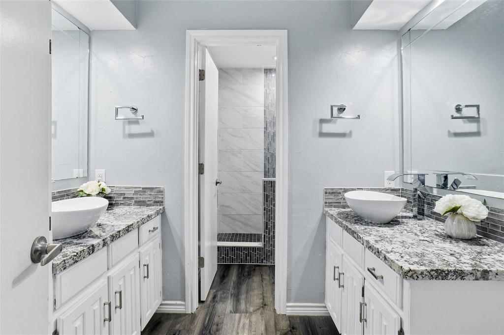 2613 Stone Hollow Drive Bedford, TX 76021 - Photo 19 of 33 a bathroom with a granite countertop sink and a mirror