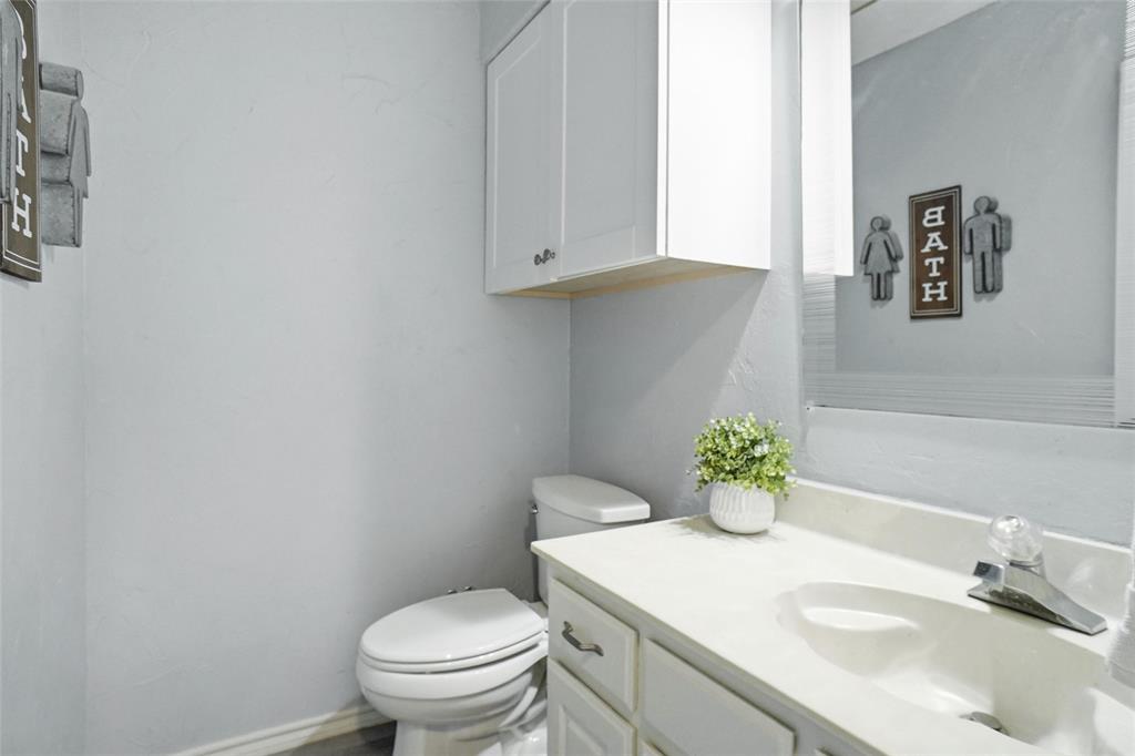 2613 Stone Hollow Drive Bedford, TX 76021 - Photo 21 of 33 a bathroom with a sink vanity and toilet