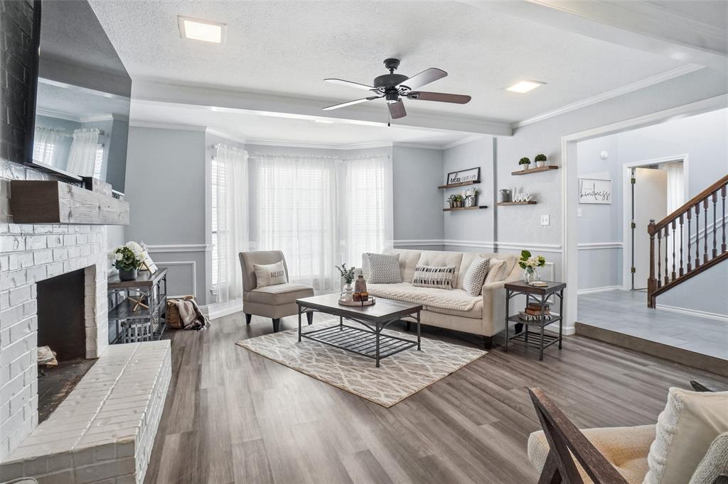 2613 Stone Hollow Drive Bedford, TX 76021 - Photo 5 of 33 a living room with furniture a fireplace and a flat screen tv