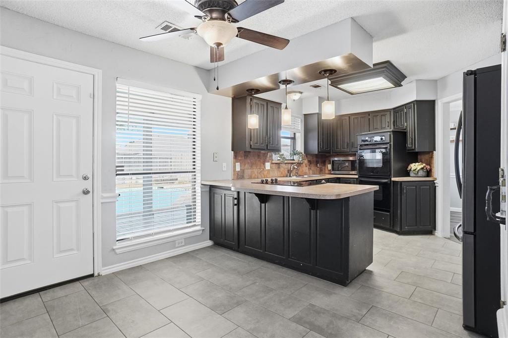 2613 Stone Hollow Drive Bedford, TX 76021 - Photo 7 of 33 a kitchen with stainless steel appliances granite countertop a refrigerator and a sink