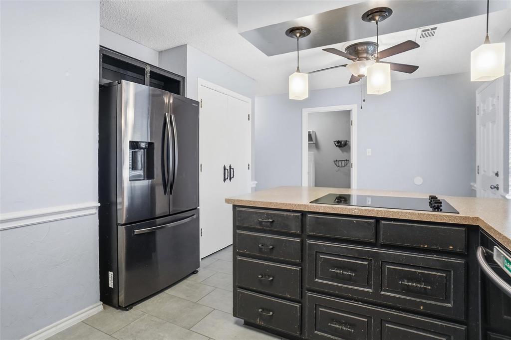 2613 Stone Hollow Drive Bedford, TX 76021 - Photo 10 of 33 a kitchen with a refrigerator and a sink