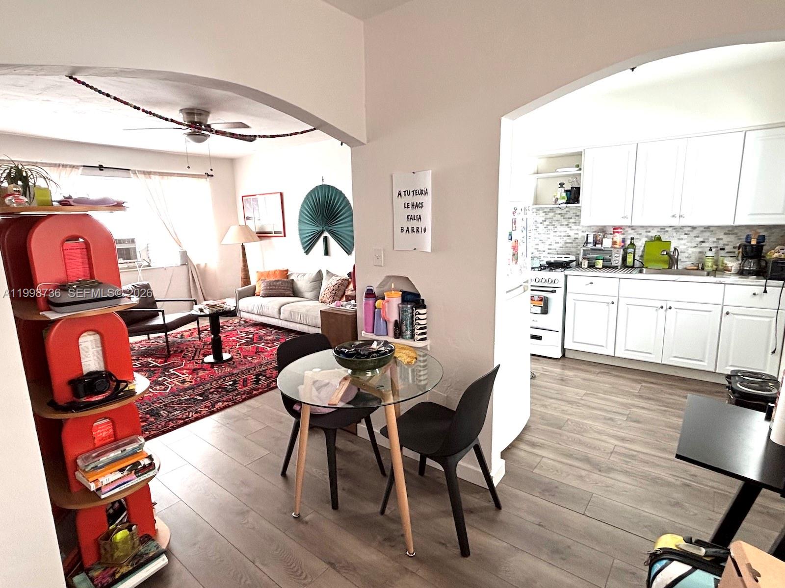 740 Southwest 7th Street, Unit 3 Miami, FL 33130 - Photo 3 of 10 a living room with furniture a table and wooden floor