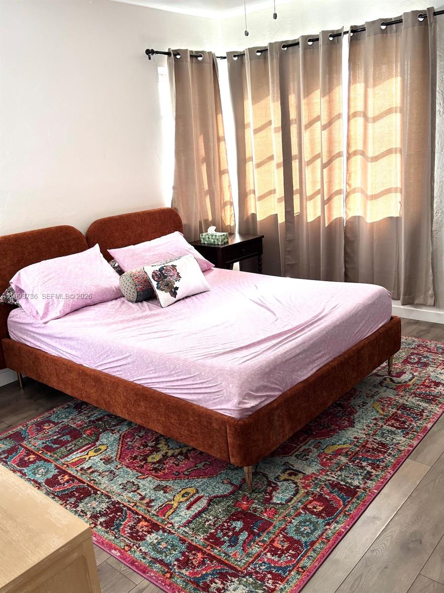 740 Southwest 7th Street, Unit 3 Miami, FL 33130 - Photo 4 of 10 a bedroom with a bed and a window