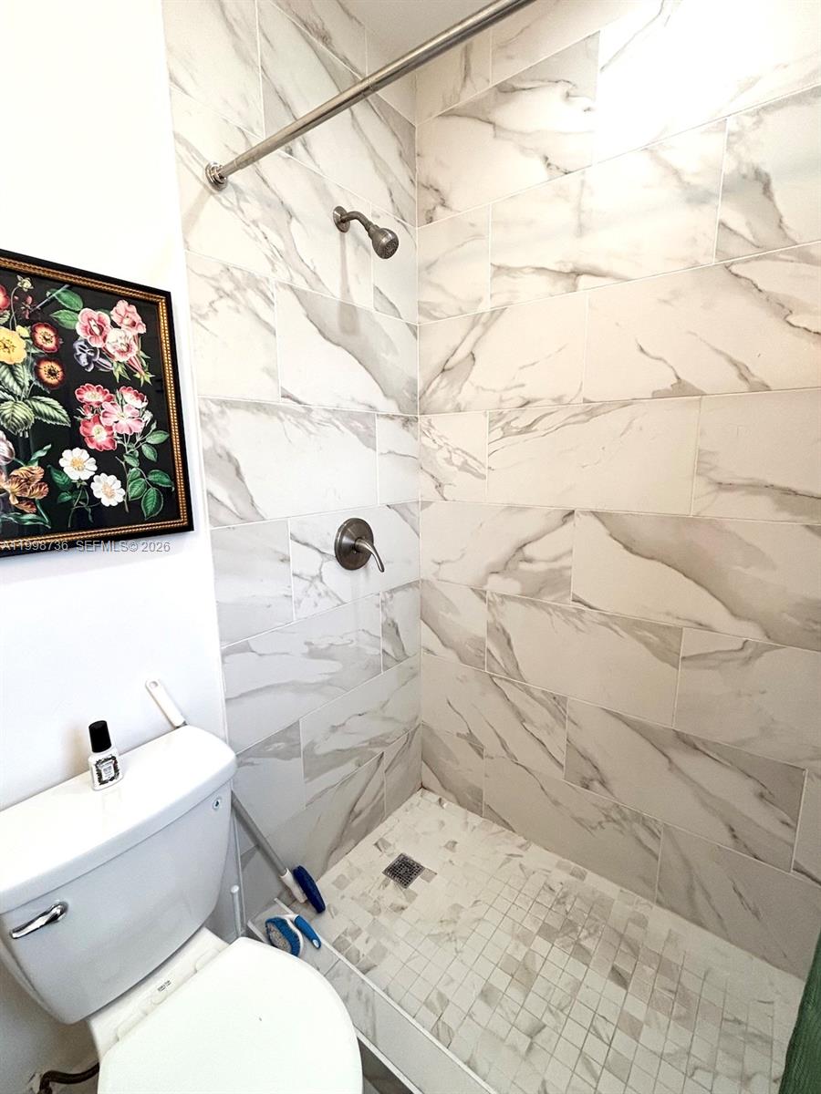 740 Southwest 7th Street, Unit 3 Miami, FL 33130 - Photo 6 of 10 a white toilet sitting next to a bathroom sink