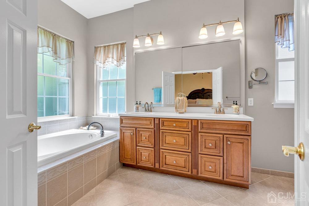 66 Kings Mill Road Monroe Township, NJ 08831 - Photo 36 of 56 a bathroom with a tub sink and mirror