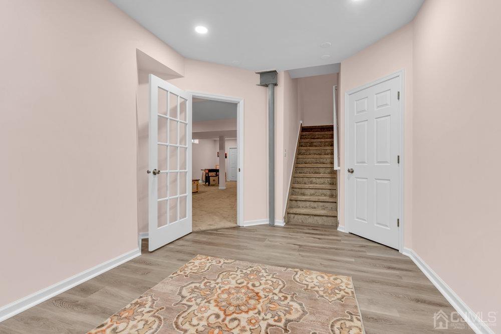 66 Kings Mill Road Monroe Township, NJ 08831 - Photo 41 of 56 a view of a hallway with wooden floor and staircase