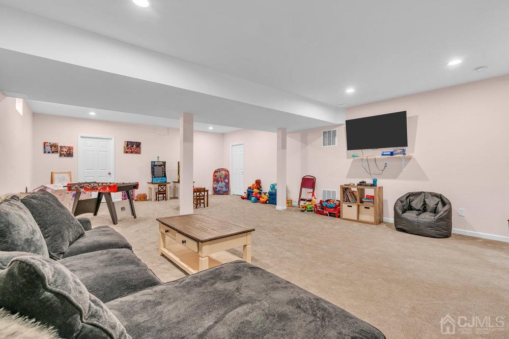 66 Kings Mill Road Monroe Township, NJ 08831 - Photo 44 of 56 a living room with furniture and a flat screen tv