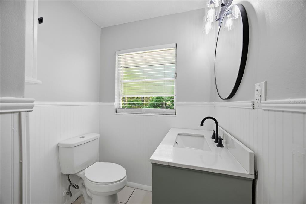 113 Browns Road San Mateo, FL 32187 - Photo 20 of 36 a bathroom with a toilet sink and mirror