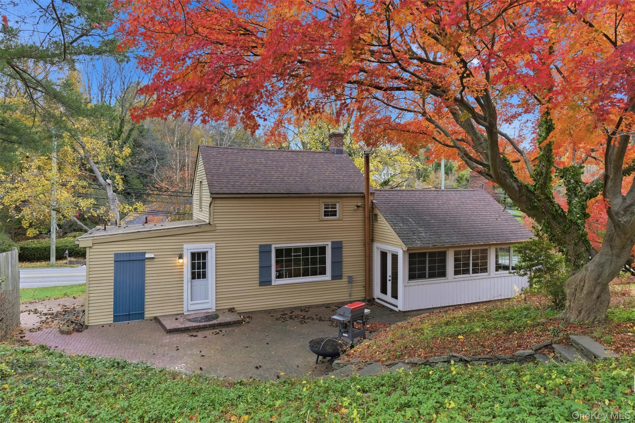 327 West Neck Road Lloyd Harbor, NY 11743 - Photo 14 of 24 a view of a yard in front of a brick house with large windows