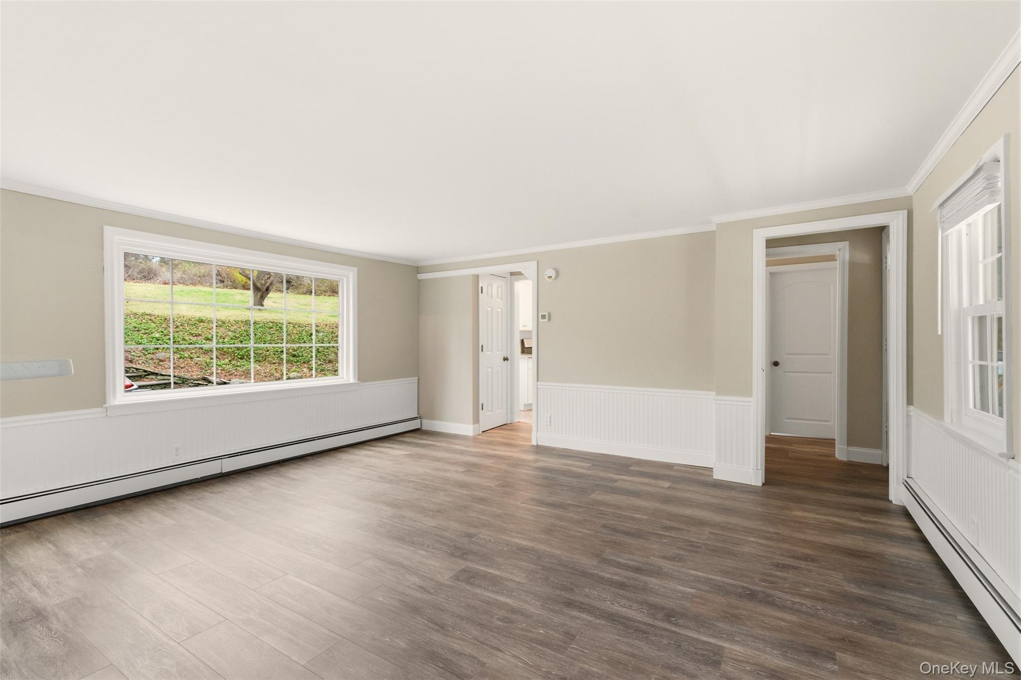 327 West Neck Road Lloyd Harbor, NY 11743 - Photo 4 of 24 an empty room with wooden floor and windows