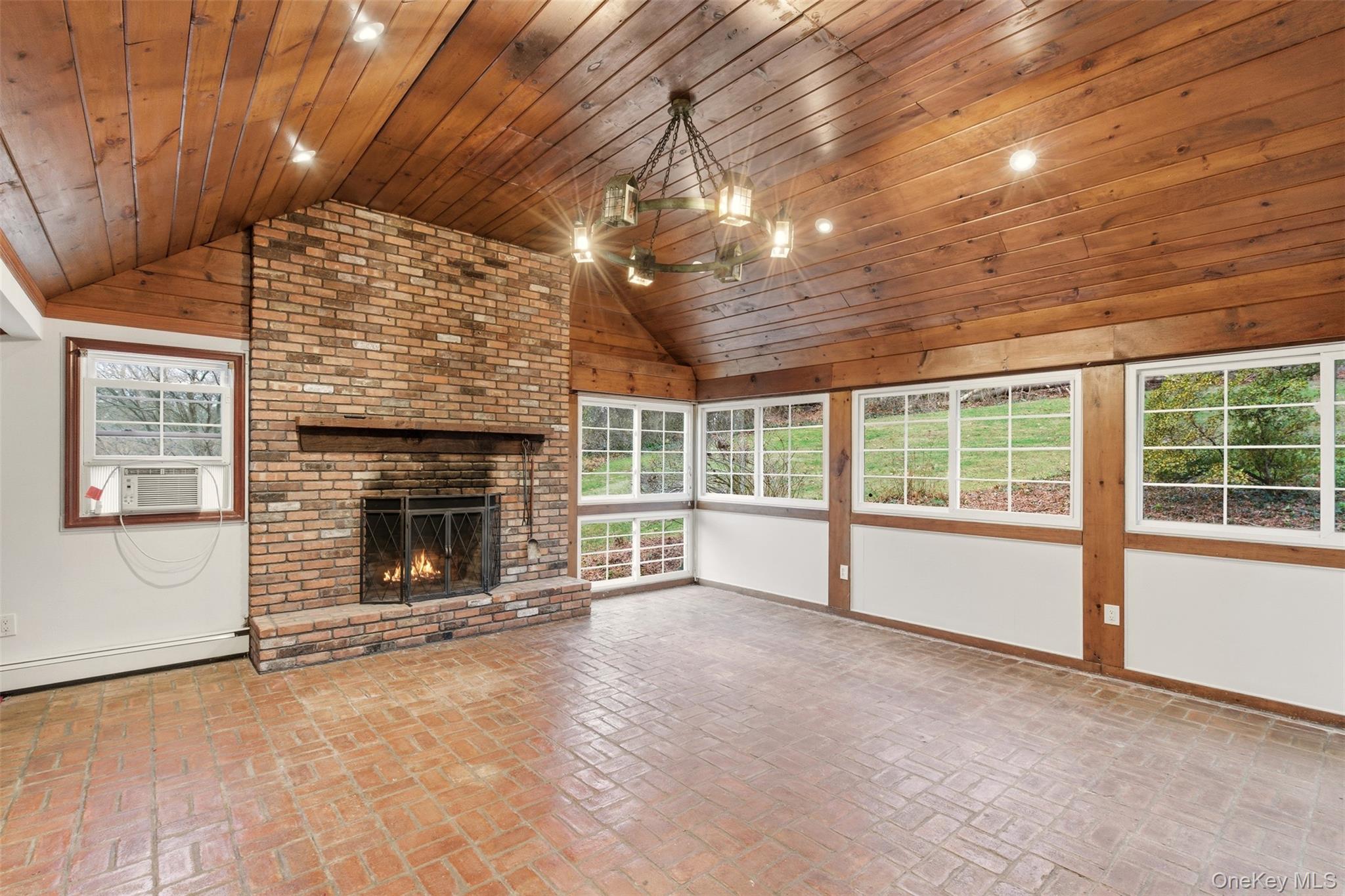 327 West Neck Road Lloyd Harbor, NY 11743 - Photo 8 of 24 a view of an empty room with a fireplace and a window