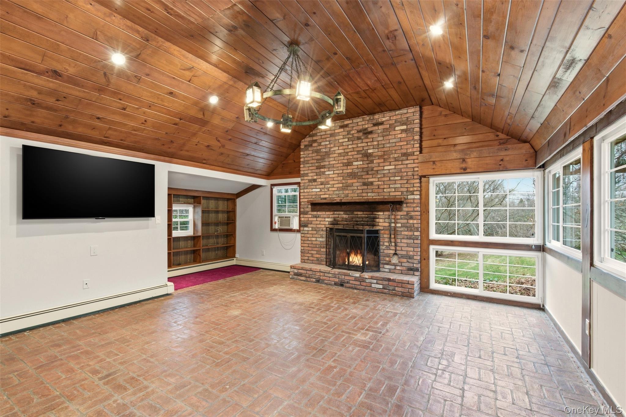 327 West Neck Road Lloyd Harbor, NY 11743 - Photo 9 of 24 a view of an empty room with a fireplace and a chandelier