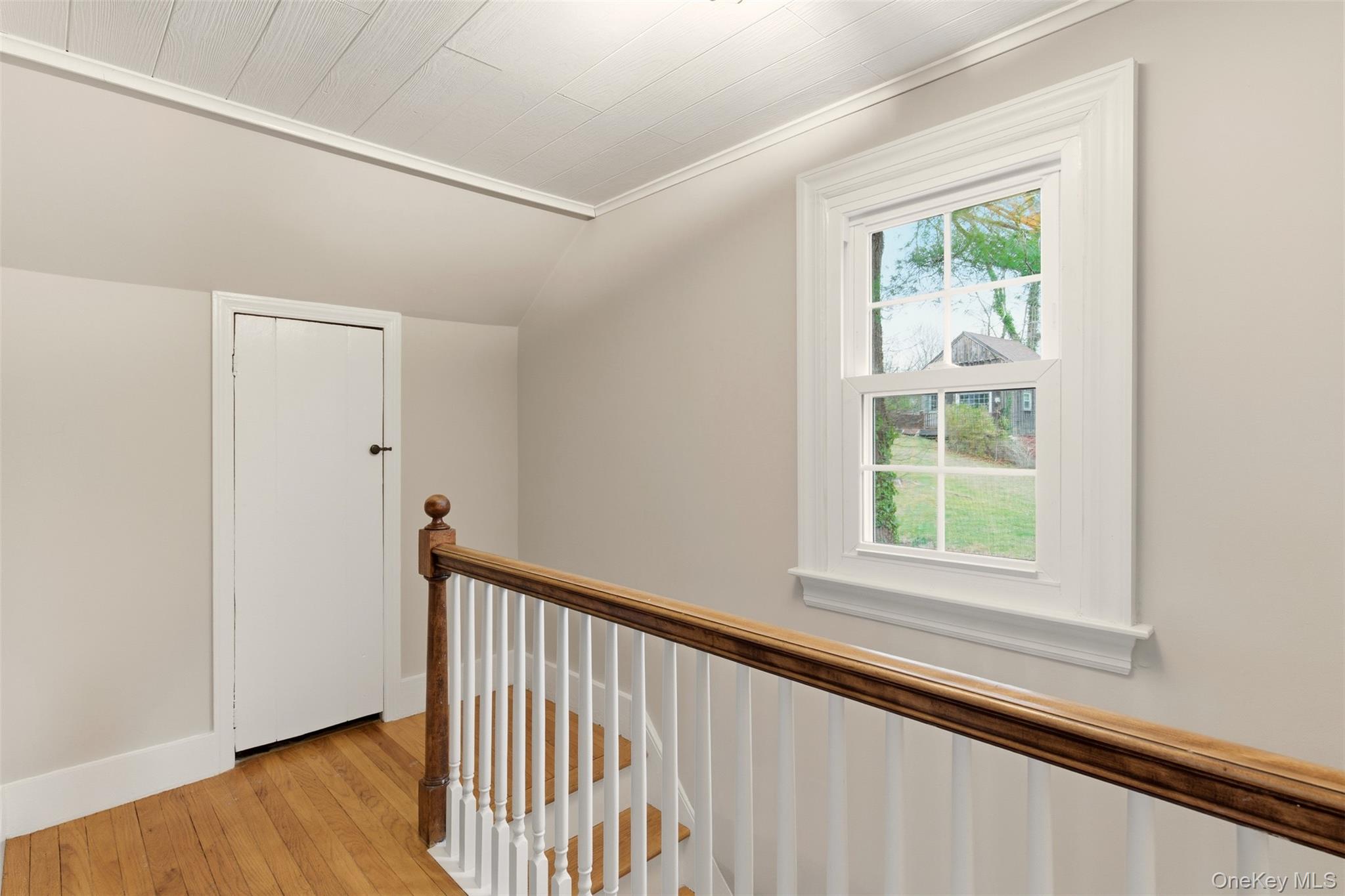 327 West Neck Road Lloyd Harbor, NY 11743 - Photo 10 of 24 a view of a hallway with wooden floor and a window
