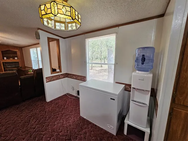 a kitchen with a sink a counter top space stainless steel appliances and cabinets
