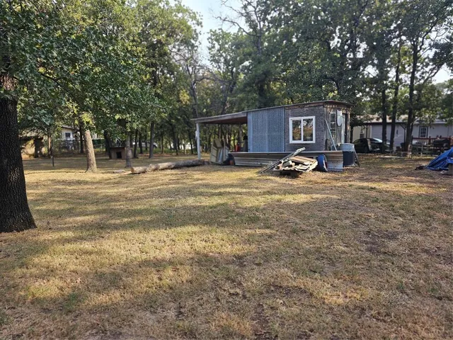 a big yard with large trees