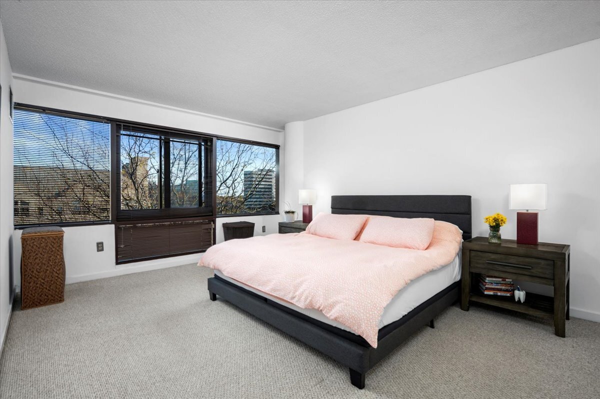 127 Greyrock Place, Unit 810 Stamford, CT 06901 - Photo 12 of 34 a large bedroom with a bed and large window