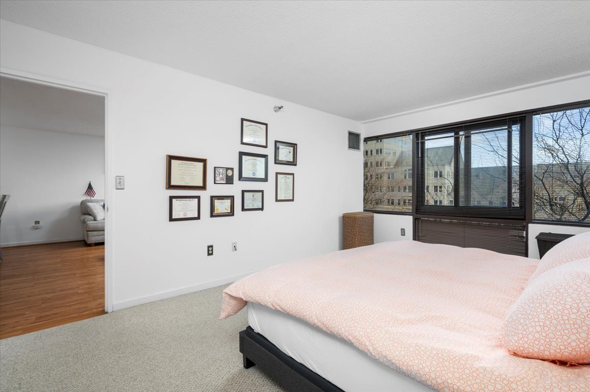 127 Greyrock Place, Unit 810 Stamford, CT 06901 - Photo 13 of 34 a bedroom with a large bed and a large window