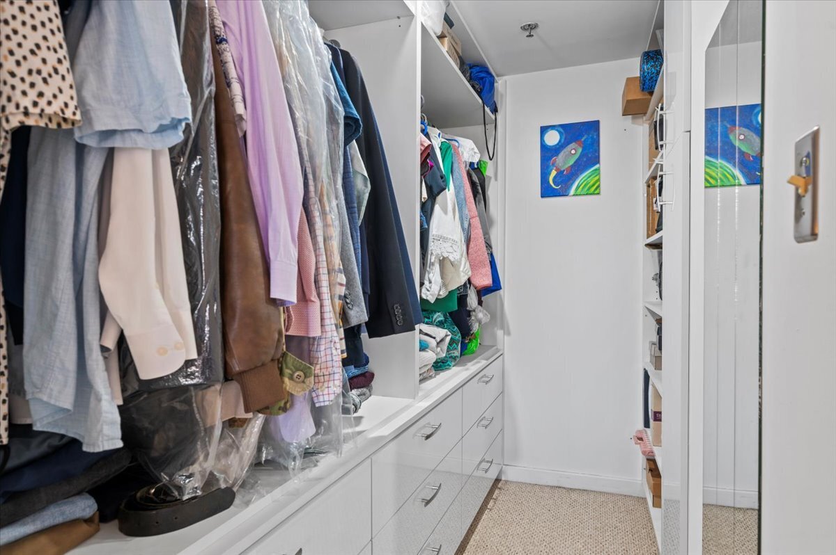 127 Greyrock Place, Unit 810 Stamford, CT 06901 - Photo 14 of 34 a view of walk in closet with clothes and shoes