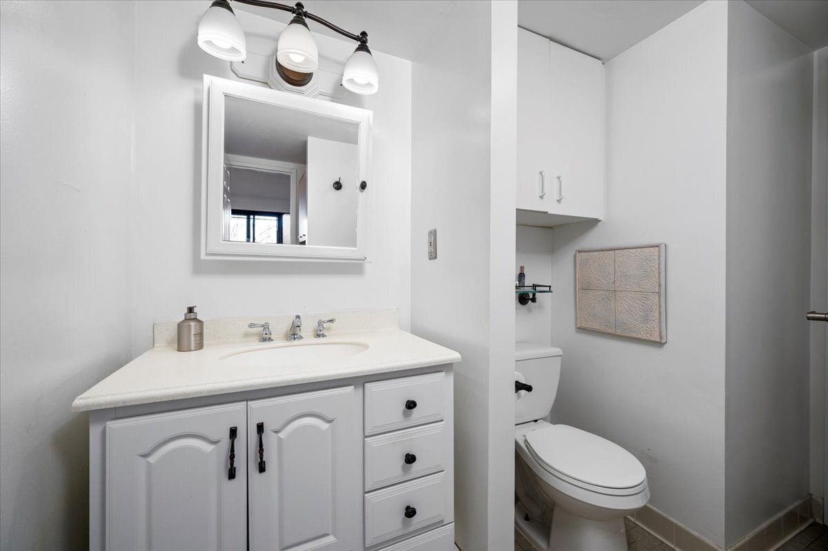 127 Greyrock Place, Unit 810 Stamford, CT 06901 - Photo 16 of 34 a bathroom with a sink a toilet and mirror
