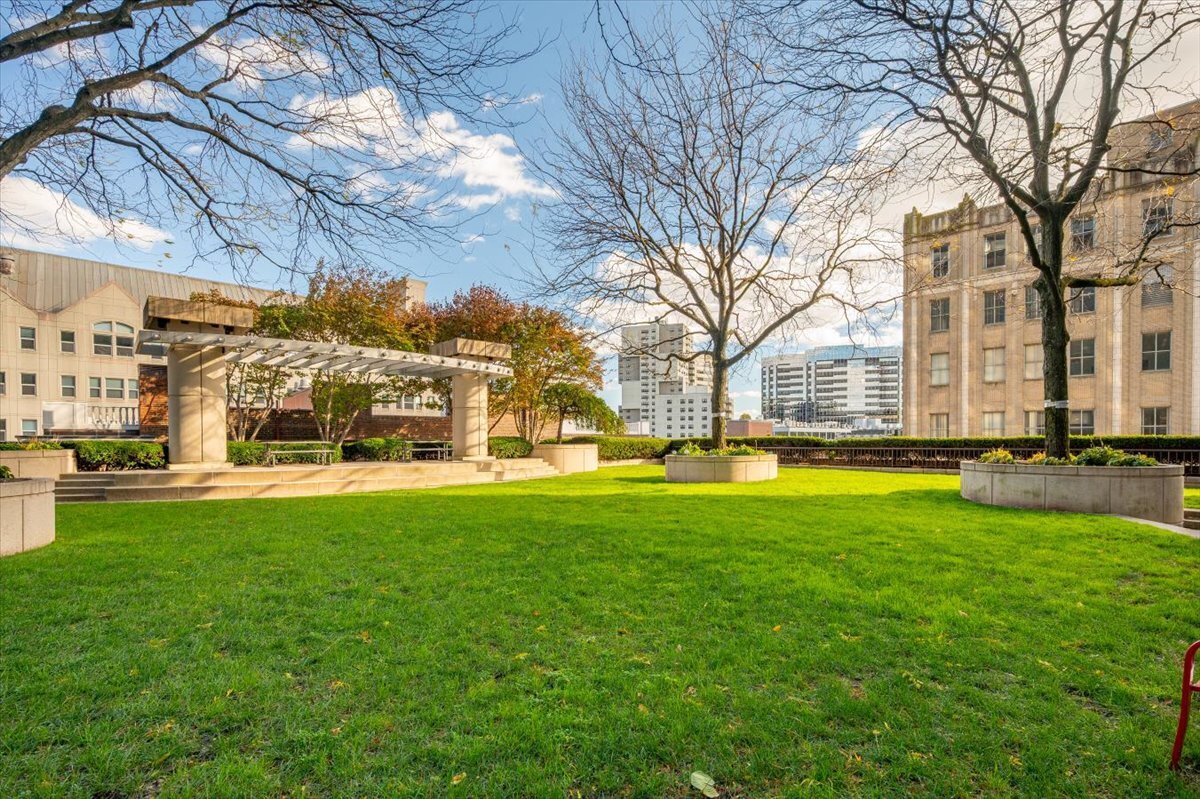 127 Greyrock Place, Unit 810 Stamford, CT 06901 - Photo 18 of 34 a view of a swimming pool with a patio and a yard