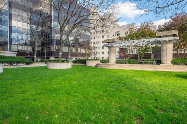 a view of a building with a yard and sitting area