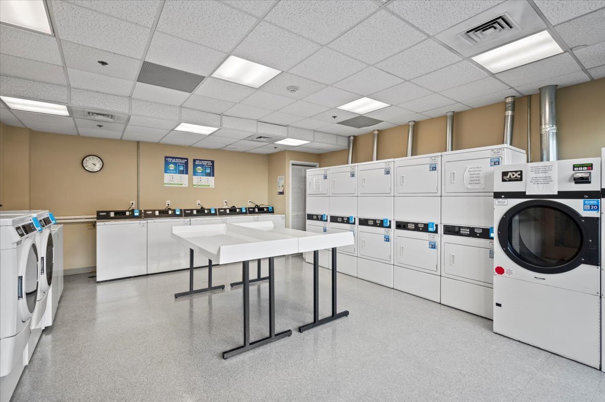127 Greyrock Place, Unit 810 Stamford, CT 06901 - Photo 29 of 34 a kitchen with cabinets and chairs