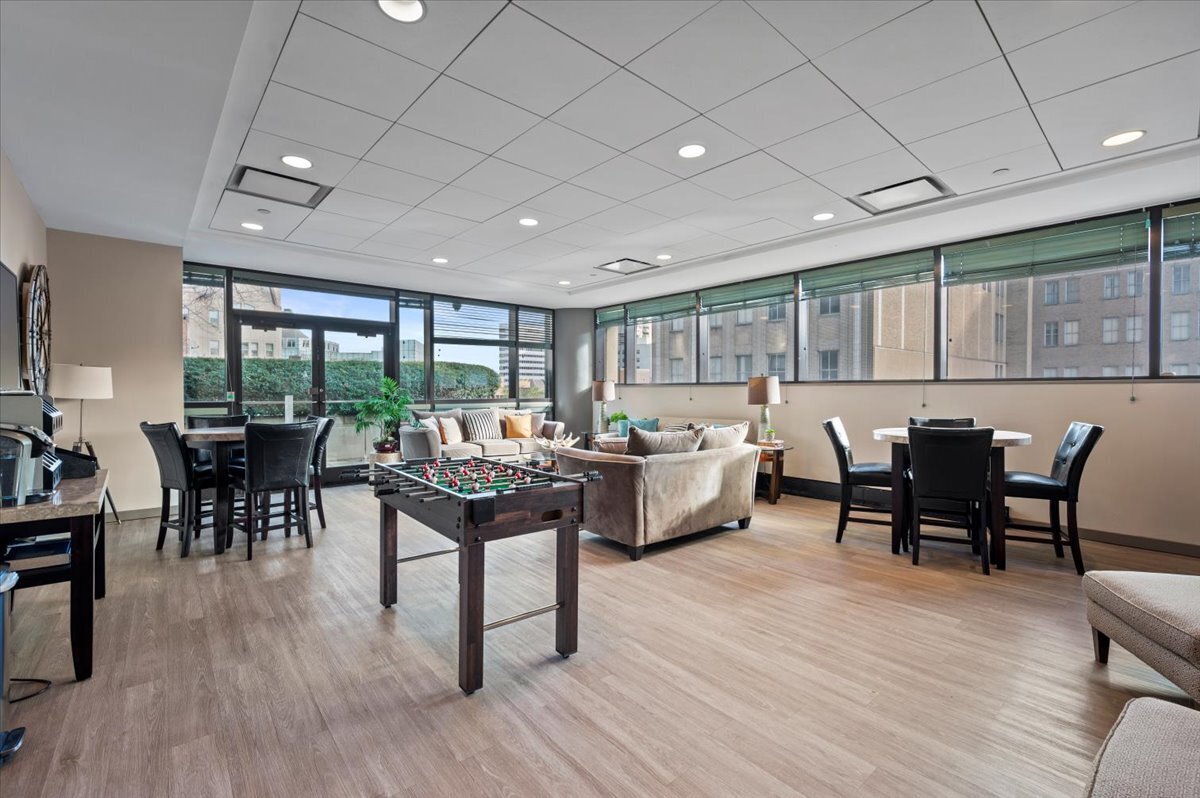 127 Greyrock Place, Unit 810 Stamford, CT 06901 - Photo 31 of 34 a view of a dining room with furniture window and wooden floor