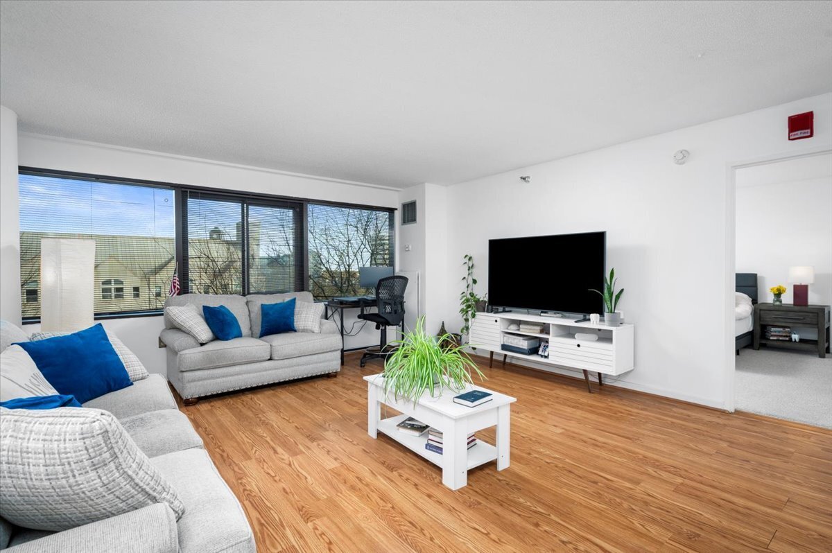 127 Greyrock Place, Unit 810 Stamford, CT 06901 - Photo 5 of 34 a living room with furniture flat screen tv and wooden floor