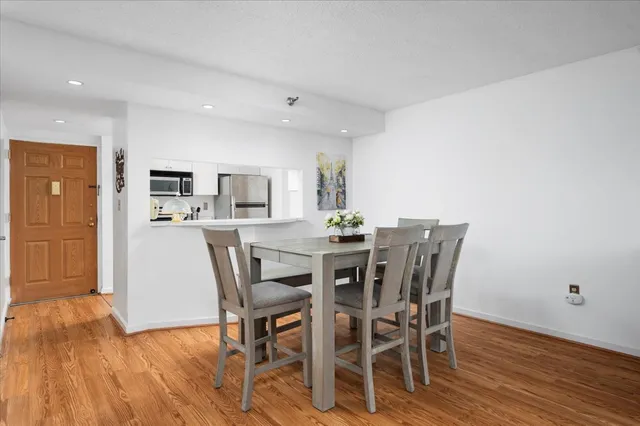 a view of a dining room with furniture and wooden floor
