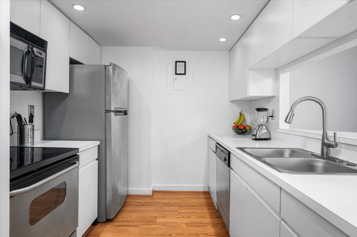 127 Greyrock Place, Unit 810 Stamford, CT 06901 - Photo 9 of 34 a kitchen with stainless steel appliances granite countertop a sink stove and refrigerator