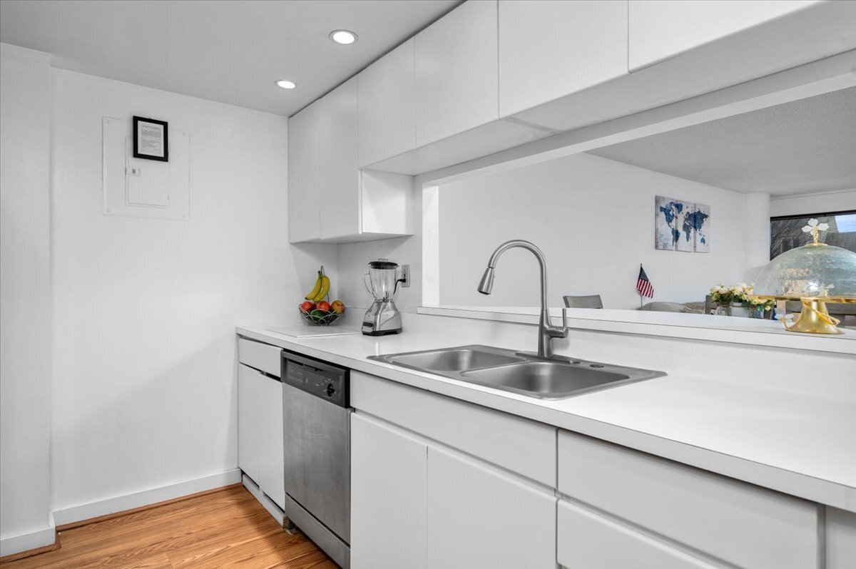 127 Greyrock Place, Unit 810 Stamford, CT 06901 - Photo 10 of 34 a kitchen with a sink and a refrigerator