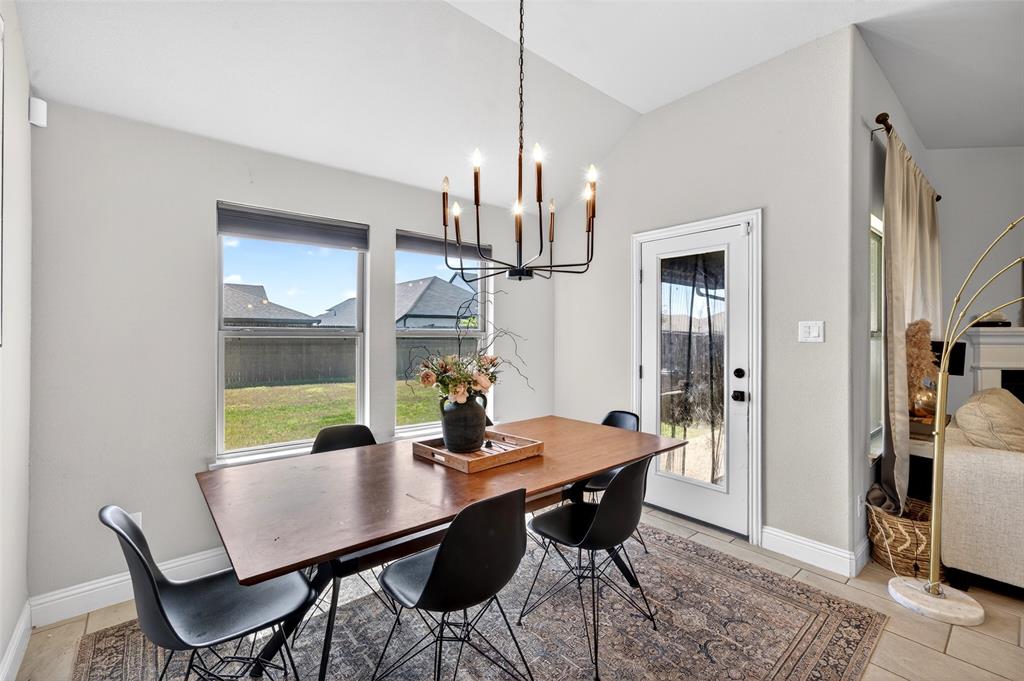 3245 Ribisl Lane Royse City, TX 75189 - Photo 12 of 39 a view of a dining room with furniture a chandelier and wooden floor