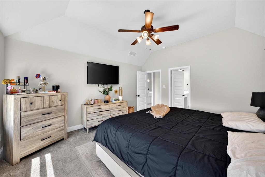 3245 Ribisl Lane Royse City, TX 75189 - Photo 18 of 39 a bedroom with a bed and a flat screen tv