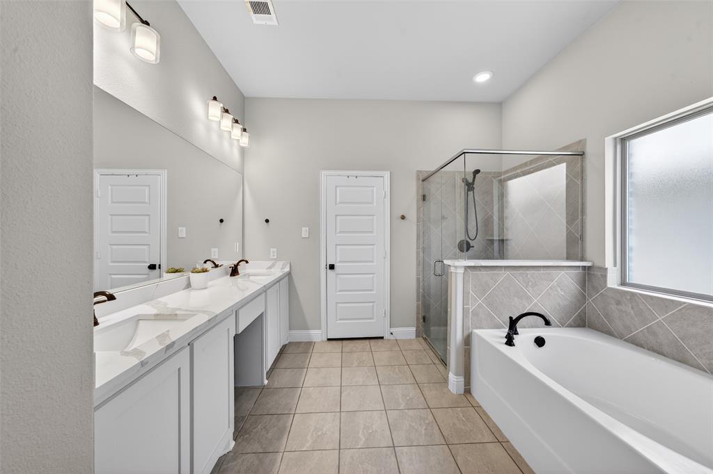 3245 Ribisl Lane Royse City, TX 75189 - Photo 19 of 39 Bathroom with double vanity, a shower stall, a bath, and light tile patterned floors