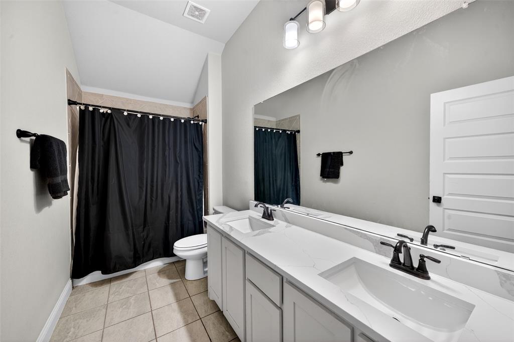 3245 Ribisl Lane Royse City, TX 75189 - Photo 26 of 39 a bathroom with a sink a toilet a mirror and shower