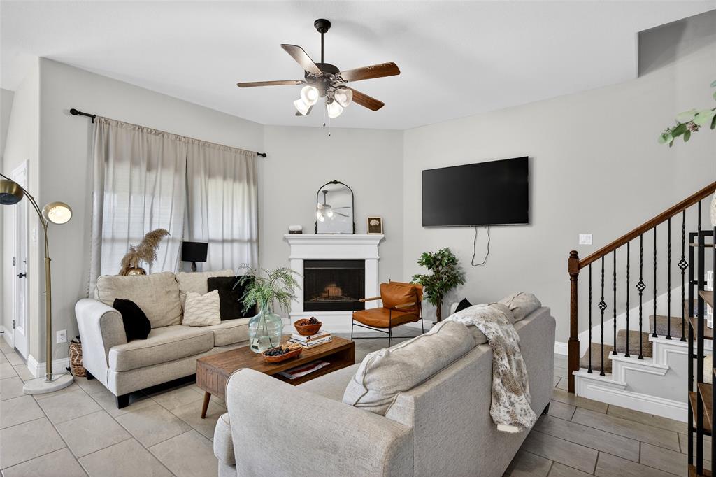 3245 Ribisl Lane Royse City, TX 75189 - Photo 5 of 39 a living room with furniture a fireplace and a flat screen tv