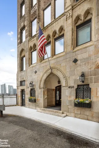 a living room with furniture a large window and a chandelier