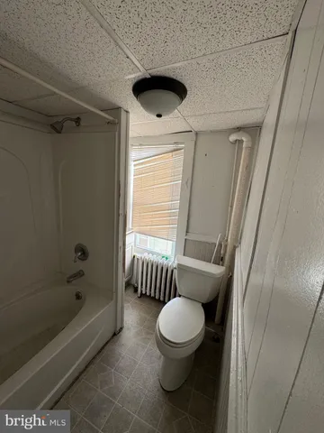 a bathroom with a toilet bathtub and shower