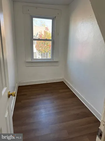a view of wooden floor and windows in a room