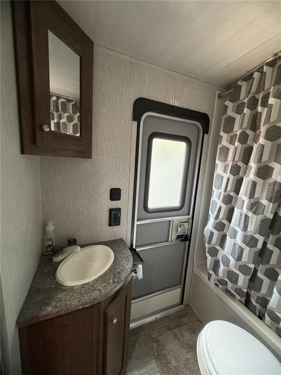 3000 Clarcona Road, Unit 743 Apopka, FL 32703 - Photo 48 of 54 a bathroom with a granite countertop toilet sink and mirror