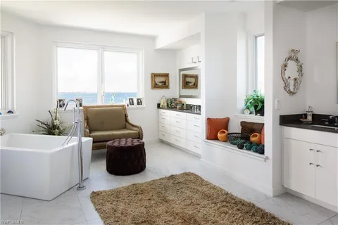 a living room with patio furniture and a chandelier