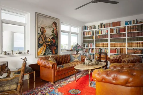a view of a dining room with furniture a chandelier and wooden floor