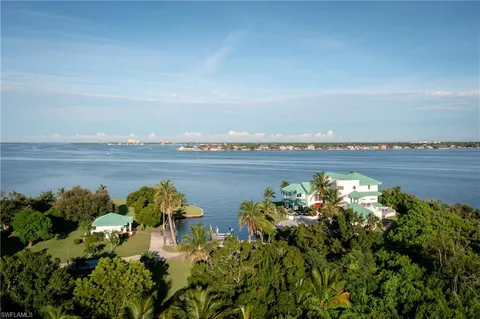 a table with chairs and potted plants on it
