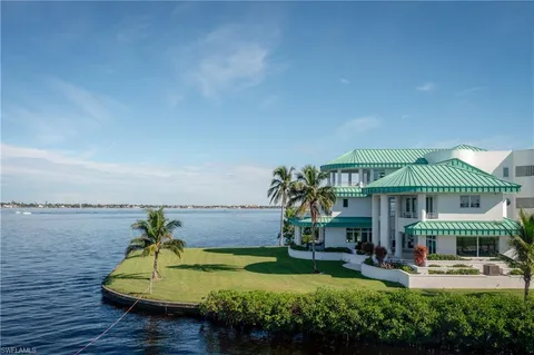a view of a balcony with furniture and potted plants