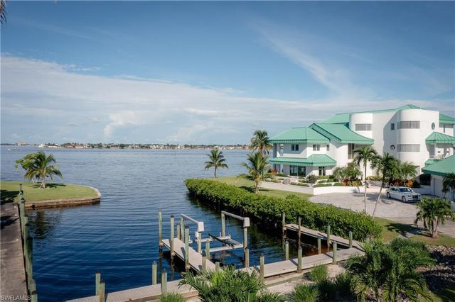 a patio with a table and chairs under an umbrella