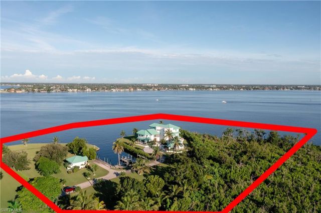 an aerial view of a house with outdoor space swimming pool and lake view