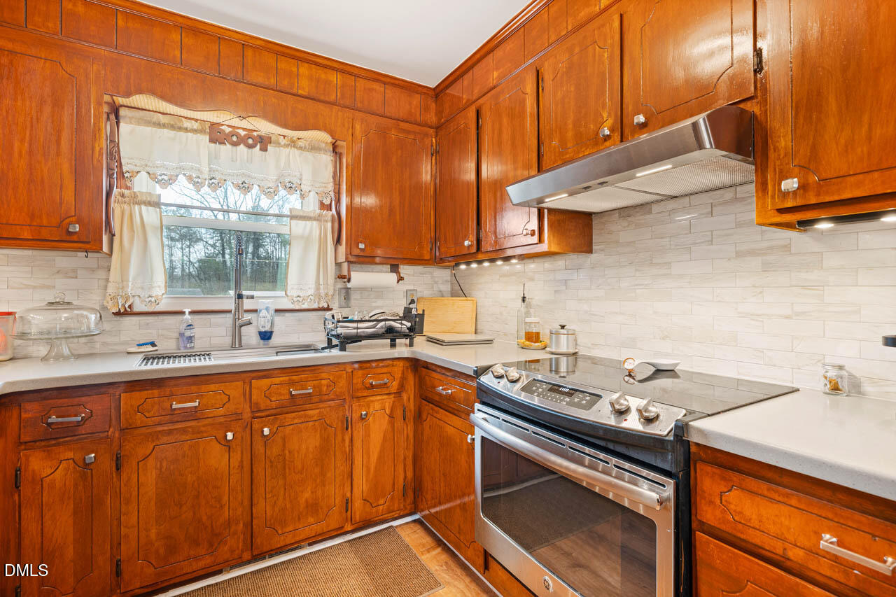 200 Sawmill Road Cedar Grove, NC 27231 - Photo 11 of 72 a kitchen with a sink stove and cabinets