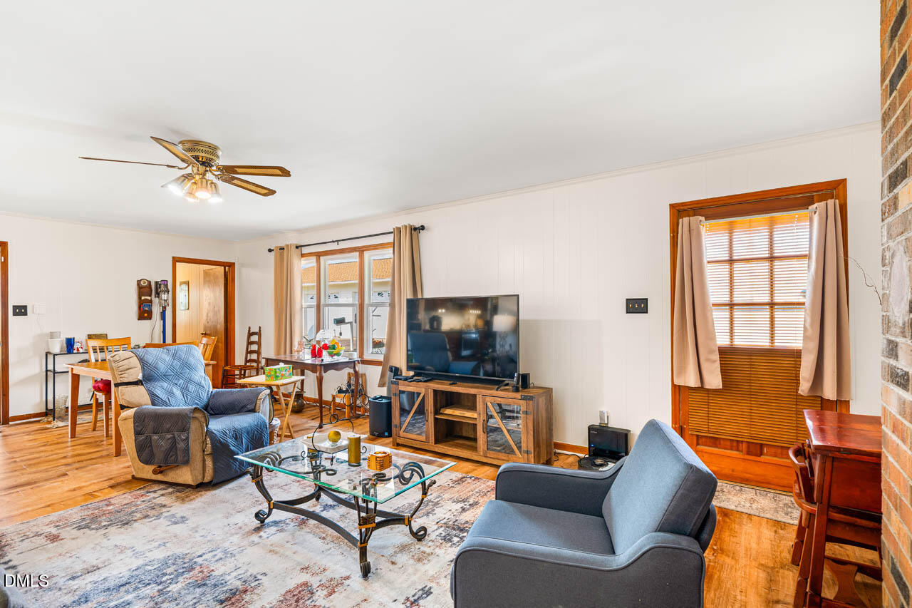 200 Sawmill Road Cedar Grove, NC 27231 - Photo 13 of 72 a living room with furniture and a flat screen tv